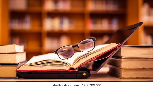 Stack of books with Glasses placed on the open book in library. - Powered by Shutterstock