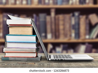 Stack Of Books With Laptop On Table