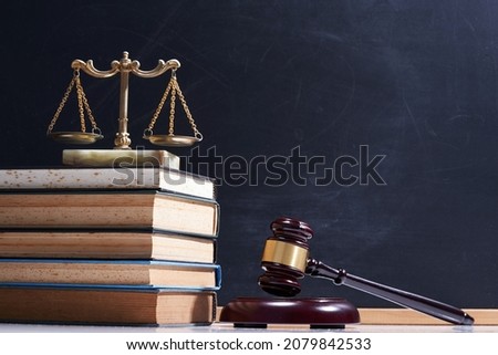 stack of books, libra scale and gavel hammer                        