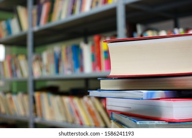 Stack of books in library - Shutterstock ID 1586241193