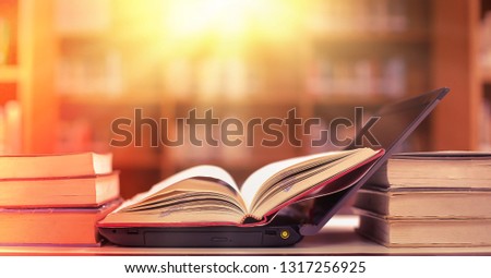 Stack of books in the library and blur bookshelf background