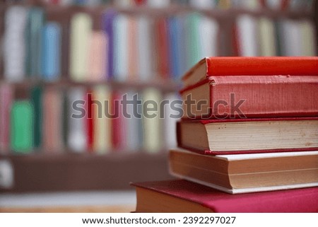 stack of books in library on blurred background