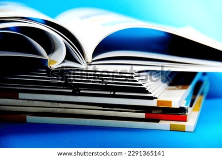 A stack of books on a blue background, close-up.