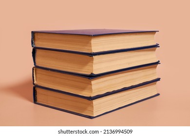 A Stack Of Books On A Colored Background. Side View, Copy Space, No People 