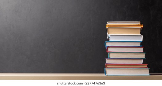 Stack of books on desk with chalkboard and space for creativity - Powered by Shutterstock