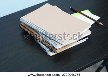 stack of books on a desk, left high angle view of books