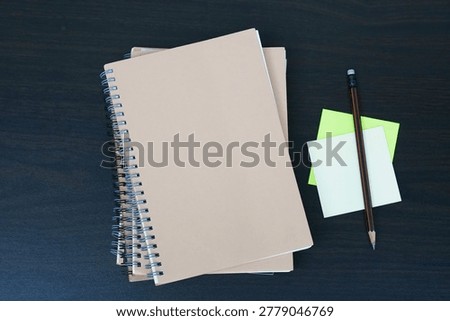 stack of books on a desk, top down angle view of books
