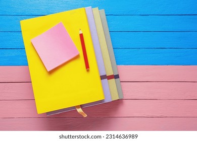 Stack of books on rustic table. Flat lay. Free space for text