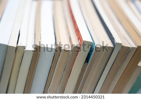 stack of books on self. abstract background with books edge. blurred corner for text. selective focus on book edge