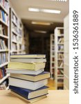 Stack of books on table in library