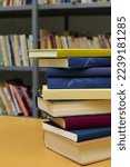 Stack of books on the table in library