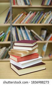 Stack of books on the table in library