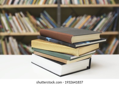 Stack of books on the table in library