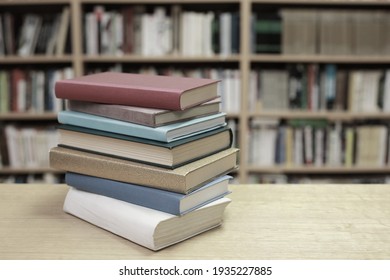 Stack of books on the table in library