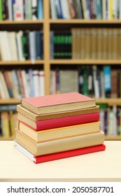 Stack of books on table in library