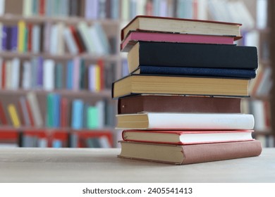 Stack of books on the table in library education