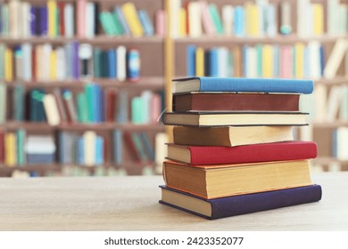 STACK OF BOOKS ON THE TABLE IN LIBRARY