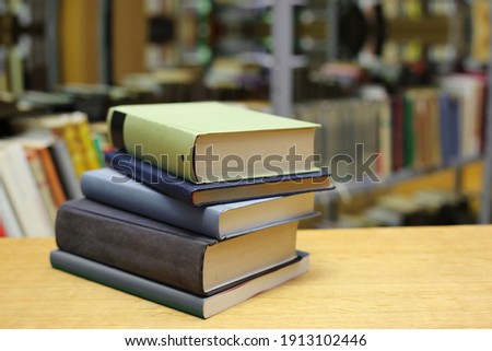 Stack of books on the table in library