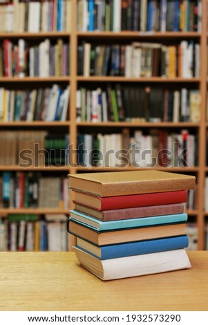 Stack of books on the table in library