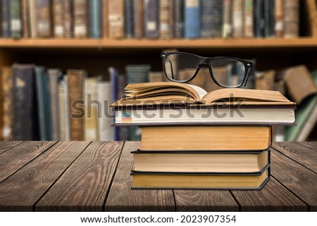 Stack of books on the table in the library background