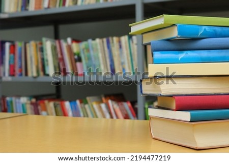 Stack of books on the table in library