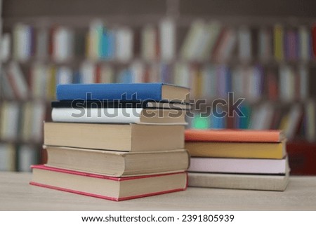 Stack of books on the table in library