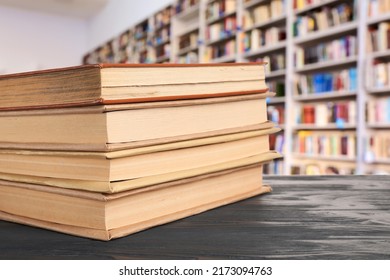 Stack Of Books On Table In Modern Library