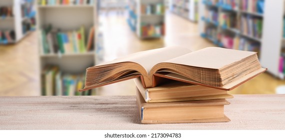 Stack Of Books On Table In Modern Library