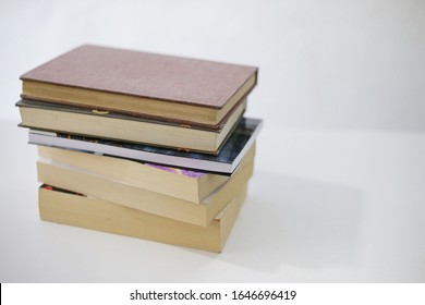 Stack of books on white table
