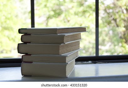Stack of Books on Window Sill