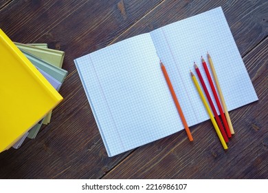 Stack Of Books And Open Notebook On Rustic Table. Free Space For Text Or Image