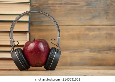 stack of books with red apple and headphone  on the wood table with copyspace - Powered by Shutterstock