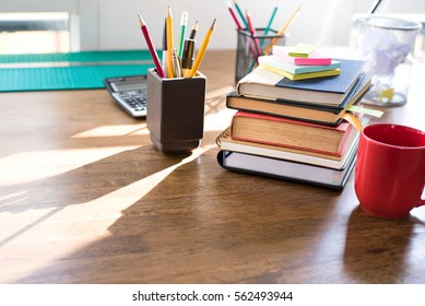 Stack Of Books And Stationery On Wood Table