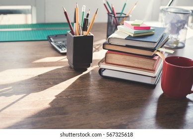 Stack of books and stationery on wood table - Powered by Shutterstock