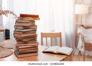Stack books or textbooks and one opened book on wooden desk in room. Literature research. Concept - information search in books. Back to school. Education and school concept. copy space