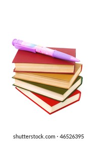 stack of books and a very large ball-point pen isolated on white
