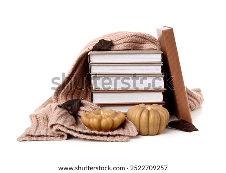 Stack of books, warm sweater and burning candles on white background