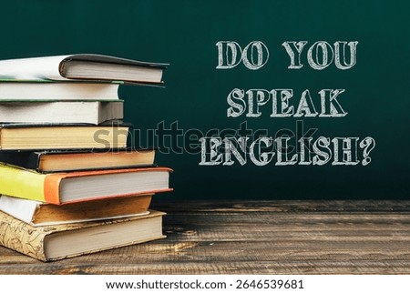 Stack of books with the words Do you speak English written on top. The books are arranged in a pyramid shape, with the top book being the largest and the bottom book being the smallest