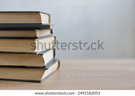stack of books,stack of books on white blurred background, education, reading, learning, studying, knowledge, literature,education background, Romance novel, crime novel, historical novel, collection 