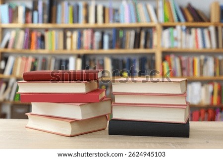 stack of books,stack of books on white blurred background, education, reading, 
High quality photos of books, Romance novel, crime novel, historical novel, collection of poems, 
