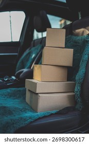 A stack of boxes sits on a car seat, suggesting a move or delivery is about to happen