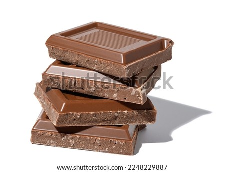 A stack of broken milk chocolate on a white isolated background, square pieces
