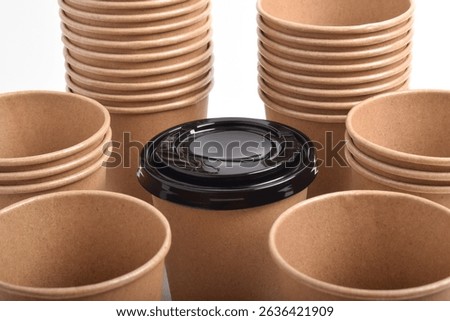Stack of the brown disposable cups isolated on white background.
