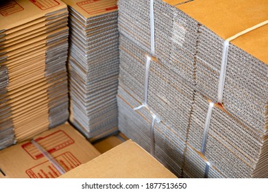 Stack of brown folded cardboard boxes tied for packaging