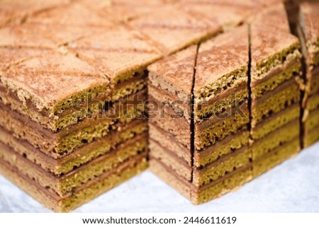 A stack of brownies with a crosshatch pattern. The brownies are cut into squares and arranged in a pyramid shape