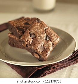 Stack of brownies on a plate.