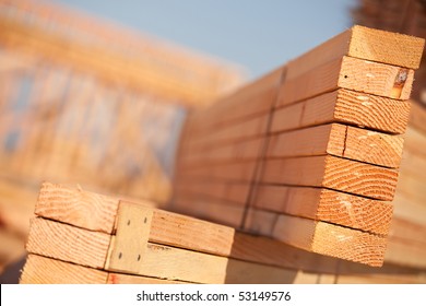 Stack Of Building Lumber At Construction Site With Narrow Depth Of Field.