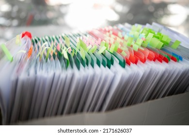 Stack Of Business Report Paper File On Modern White Office Desk With Bokeh Background.