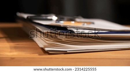 Stack of business report paper file on modern white office desk