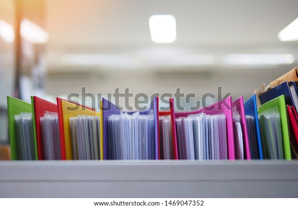 Stack or cabinet of document\
files in the office, business, finance, or education concept\
picture of pile of colorful files of papers in the business firm or\
company
